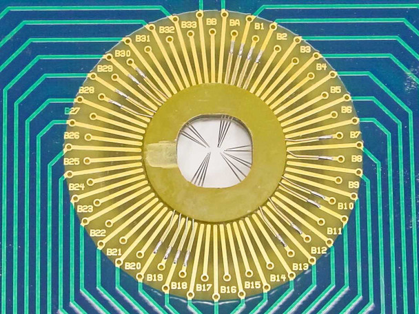 Macro close-up of the radial gold contact array on the 110-147C Rev G DAS Device PCB showing labeled contact pads B1 through B33 arranged in a circular pattern