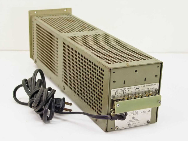 Lambda LP-521-FM rear view showing green terminal block for load connections, AC power cord attached, and Lambda Electronics Corp rating plate