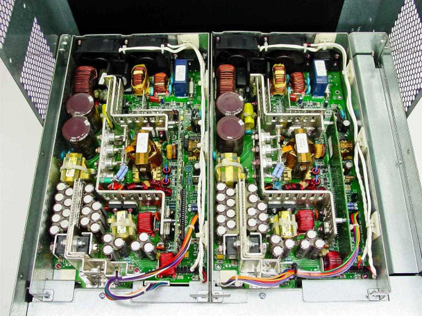 Extreme Networks Summit 7i — interior view showing both dual power supply PCBs side by side with capacitors, inductors, and transformers