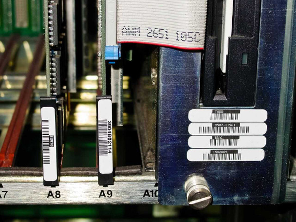 Octel VMX200 interior view of card slots A7–A10 showing card labels including 300-6002-114, ribbon cable connector AWM 2651 105C, and floppy drive module at A10 position