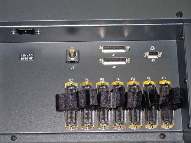 Octel VMX200 rear panel lower section showing 120 VAC 50/60 Hz label, J2 and J3 DB connectors, J4 toggle switch, and seven DB25 telephone line ports P1–P7 with bundled cable straps