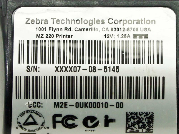 Zebra MZ220 bottom label showing model number, 12V 1.25A power rating, serial number, and FCC ID M2E-0UK00010-00