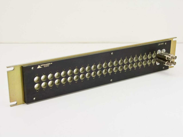Trompeter JSI-48A patch panel — front 3/4 view, black panel with gold rack ears, 48 positions populated with white jacks and BNC connectors on right side