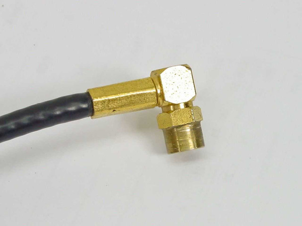 Close-up of gold-plated SMA male right-angle connector end showing brass body and threaded coupling