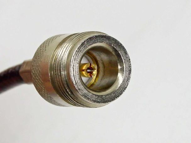 Close-up of N female connector face showing center socket, gold contact, and dielectric insert