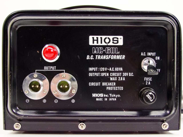 HIOS MC-60L DC Transformer front panel close-up showing dual circular output connectors labeled positive and negative, ON/OFF toggle switch, 2A fuse holder, and HIOS Inc Tokyo Made in Japan label