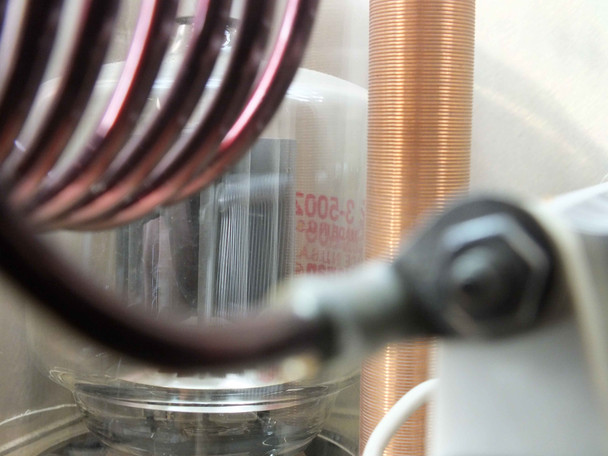 Interior angled view through the RF deck chassis showing a 3-500Z tube partially obscured by wiring and coil components