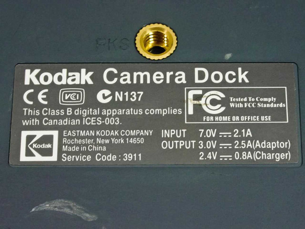 Kodak Camera Dock bottom label showing input 7.0V 2.1A, output specs, FCC/CE markings, and Made in China