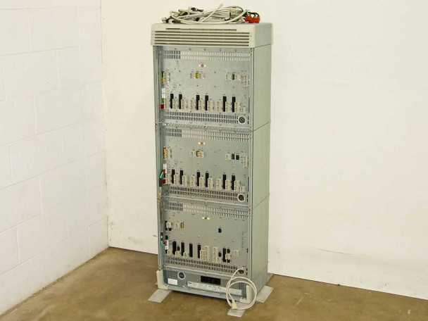 Rolm 9200 PBX 3-stack chassis – rear three-quarter view showing all three bays, rear connector panels, and power cable