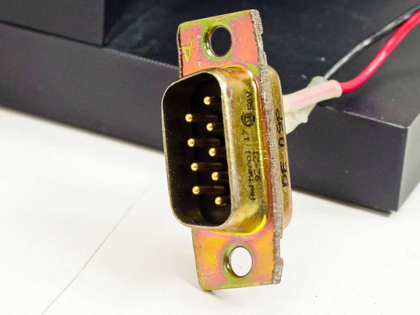Close-up of DB9 male 9-pin D-sub connector on electronic shutter assembly with red and gray wiring leads visible