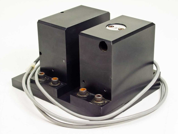 Rear view of dual-block electronic shutter assembly showing gray multi-conductor cable routing and four mounting studs on base