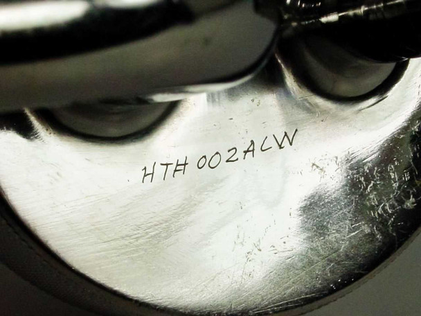 Close-up of vacuum port base underside showing hand-engraved marking HTH002ACW