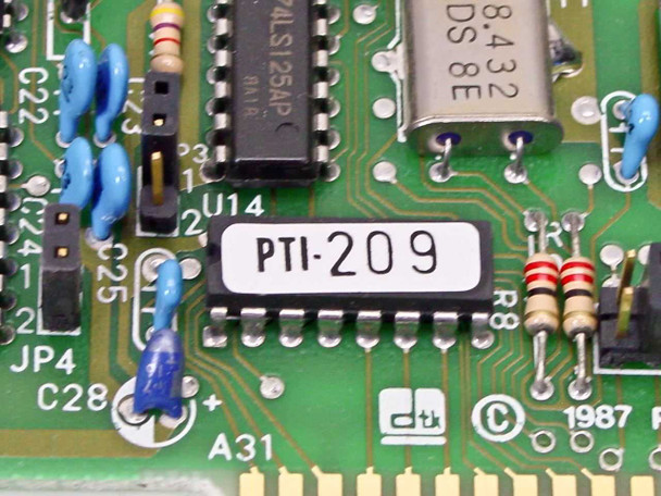 DTK PTI-209 close-up of PCB label, 74ALS125AP logic IC, 8.432 MHz oscillator, and 1987 copyright markings