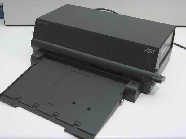 AST PowerStation III Docking Station 501681-001 — front three-quarter view showing laptop bay open and AST logo on top right
