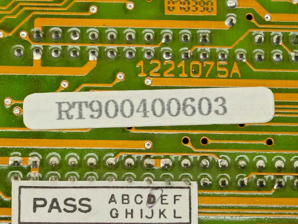 Dynova RT900400603 part number label and PASS QC inspection sticker close-up on PCB solder side