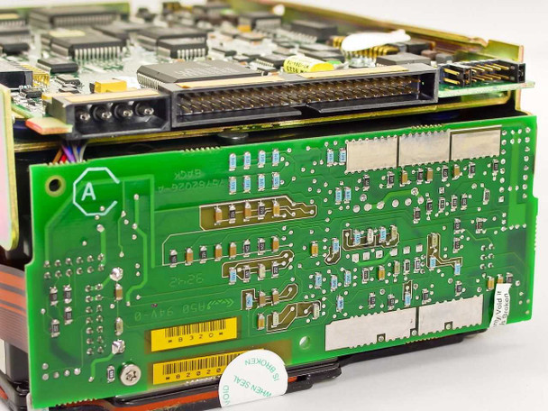 Seagate ST41200NM PCB bottom view showing SCSI interface connector, jumper header, and secondary logic board with warranty seal