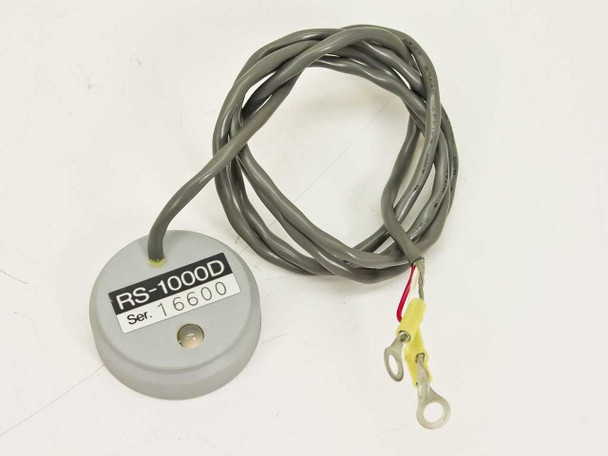 Hitachi RS-1000D Sensor Head front label view showing model number RS-1000D and serial number, with attached gray cable and yellow ring terminals