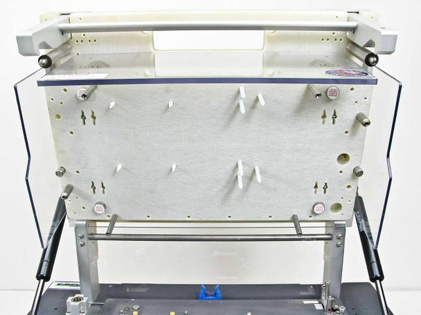 Underside of laminator platen assembly — aluminum plate with mounting pins and support structure visible with unit arm fully raised