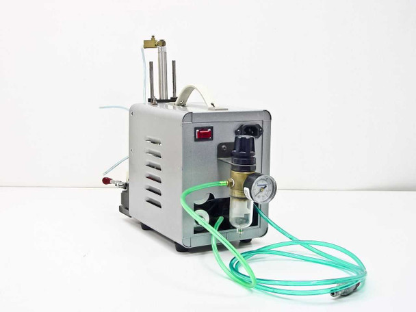 Ultramation OA-4 Pneumatic Linear Thruster – front-left view showing illuminated red rocker switch, Wilkerson pressure regulator with gauge, green tubing connections, and IEC AC power inlet on side panel