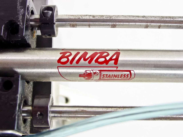 Close-up of Bimba Stainless branded stainless steel cylinder rod on the Ultramation OA-4 Linear Thruster showing 'BIMBA STAINLESS' logo in red with green pneumatic tubing