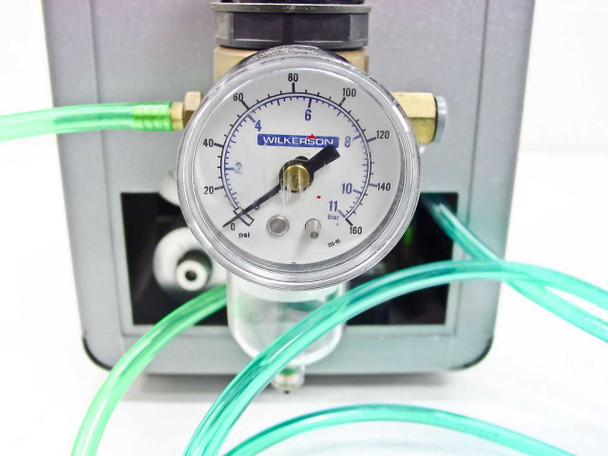 Close-up of Wilkerson pressure regulator and gauge on Ultramation OA-4 showing 0–160 psi dial gauge with clear bowl moisture separator and green tubing connections