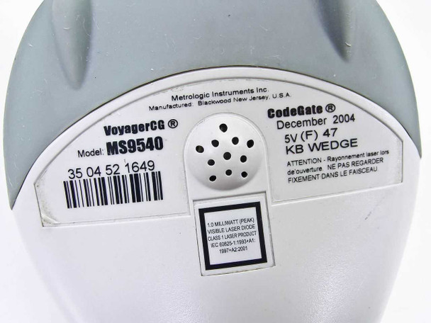 Metrologic MS9540 VoyagerCG label showing model number, CodeGate branding, December 2004 manufacture date, 5V rating, and Class 1 laser notice