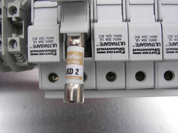 Close-up of Ferraz Shawmut ULTRASAFE fuse holders on DIN rail — open fuse holder displaying Littelfuse KLKD 2 fast-acting 2A fuse, fuse holder labels showing 800V/30A UL and 690V/32A IEC ratings