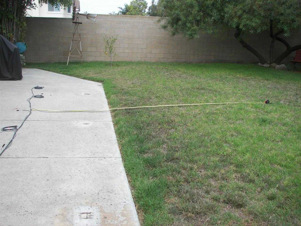 First Solar wiring harness common wire laid across backyard lawn showing approximate total run length