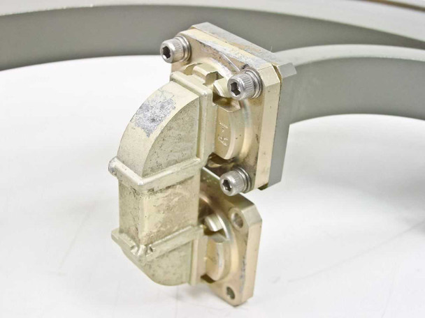 Close-up of WR-62 waveguide flange end showing brass/gold hardware, mounting screws, and articulating connector section