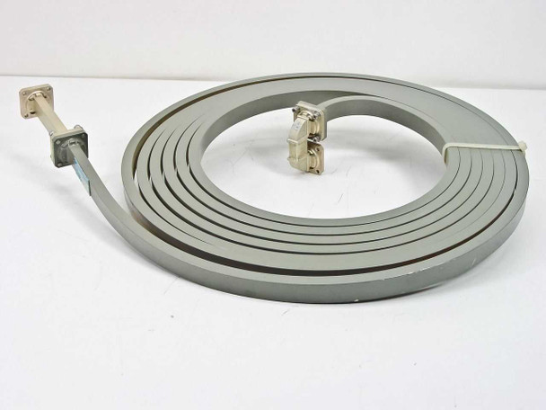 Micro-Coax 1010 WR-62 Ku-Band flexible waveguide delay line coiled overhead view showing full 20-ft length with both flanged ends visible