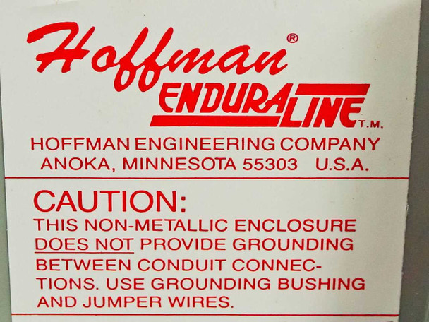 Hoffman Endura-Line label showing non-metallic enclosure caution regarding grounding between conduit connections — use grounding bushing and jumper wires
