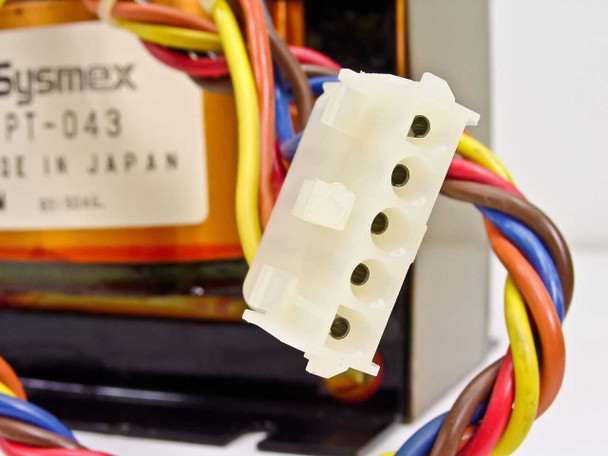 Close-up of white molex-style multi-pin output connector on the Sysmex PT-043 transformer secondary lead