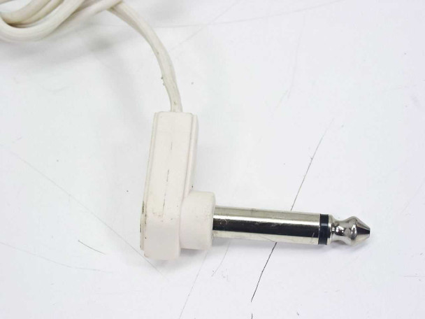 Close-up of the white right-angle 1/4 inch mono TS plug at the end of the headphone cable