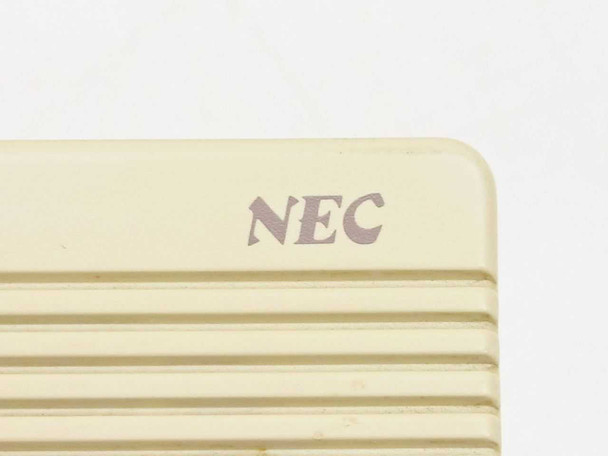 NEC ETT-1-1 rear speaker grille with NEC logo printed on beige plastic housing