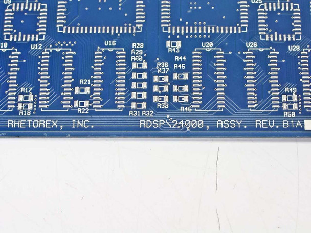 Close-up of Rhetorex RDSP24000 PCB silkscreen reading RHETOREX INC RDSP24000 ASSY REV B1A