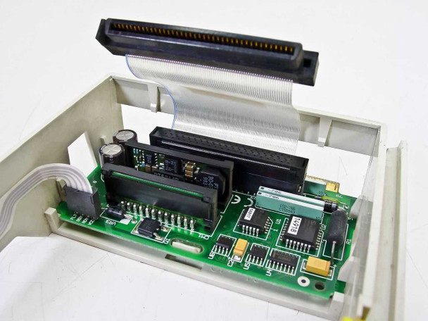 Premier 118-027475 caddy interior — close-up of 80-pin SCSI connector, interposer PCB with ICs and ribbon cable