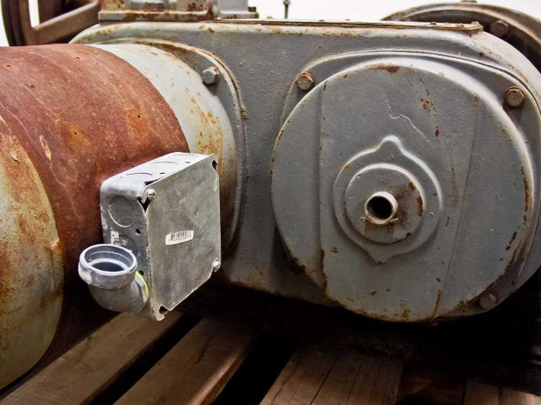 Close-up of conduit junction box and output shaft end cover on GE 7GP358MA3AA motor, showing casting detail and surface rust