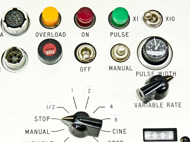 Close-up of Traid Corp intervalometer controller panel — Overload, ON, Pulse indicators, fuse, OFF/MANUAL toggles, frames/second selector dial, variable rate and pulse width knobs