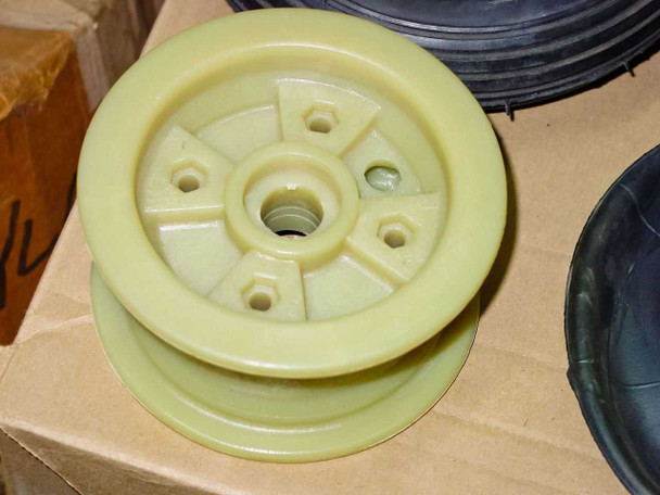 Front view of yellow nylon hub showing spoke pattern, center axle bore, and mounting bolt holes