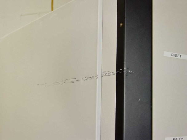 Queue Systems QU2195D12 Cryostar – interior side wall close-up showing surface scratches and scuff marks, with shelf label tabs visible