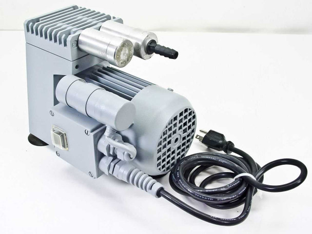 Vacuubrand ME 2S vacuum pump — left-rear view showing NEMA power cord, on/off switch panel, and inlet/outlet hose barb fittings at top