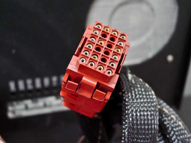 Close-up of red multi-pin interconnect connector from the cable harness between the Delsa 440SX main unit and remote power supply