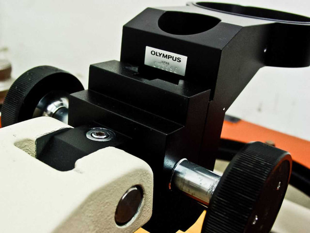Olympus Japan microscope mount/holder bracket — black anodized block with adjustment knobs and mounting arm; no microscope body attached
