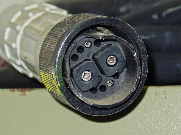 Close-up of Varian HFS-1000D multi-pin circular power connector end showing two square contacts and locking ring