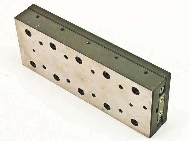 End view of linear slide micropositioner stage showing table thickness and anodized carriage body with adjustment hardware