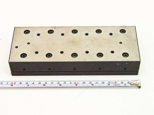 Top-down view of linear slide micropositioner stage with measuring tape confirming 8.125 inch table length