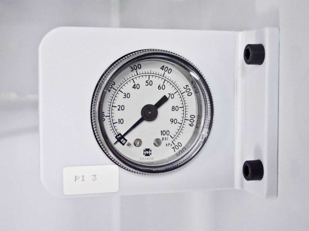 Close-up of in-cabinet pressure gauge labeled PI 3 mounted on white bracket inside FSI ChemFill canister bay