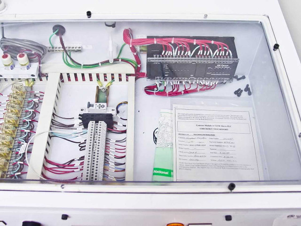 Interior electronics compartment showing GE Fanuc Series 90 Micro PLC module mounted in upper right, terminal blocks, wiring, and a printed canister module GE/CCM checkout test report document visible