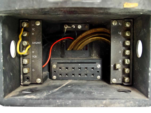 Interior bottom compartment of Wheelco Model 402 showing wiring terminal block with labeled screw terminals including TC+, TC-, SHUNT, TCB+, TCB-, G, L1, L2 and numbered terminals, with red and yellow lead wires and central multi-pin connector block