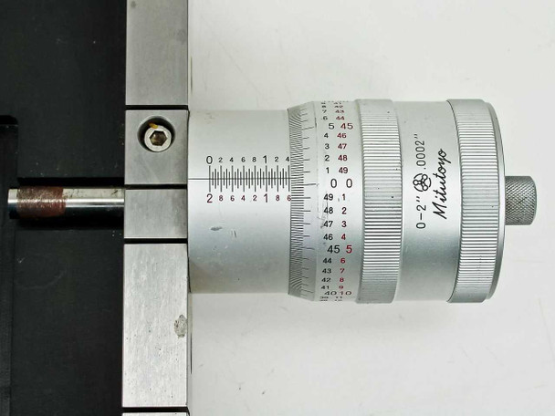 Mitutoyo 197-201 micrometer head close-up showing '0–2 Mitutoyo' and '.0002in' resolution, with stage rail linear scale in background